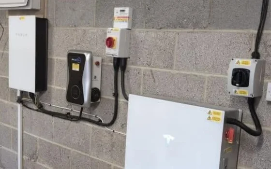 A real Future Power Team Tesla Powerwall 3 install — wall-mounted unit beside a Zappi EV charger in a Yorkshire garage